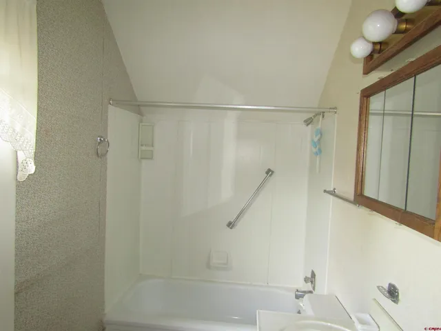 a bathroom with a shower and a sink