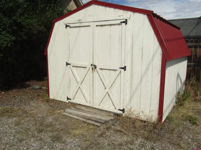 a view of a backyard with garage and entryway