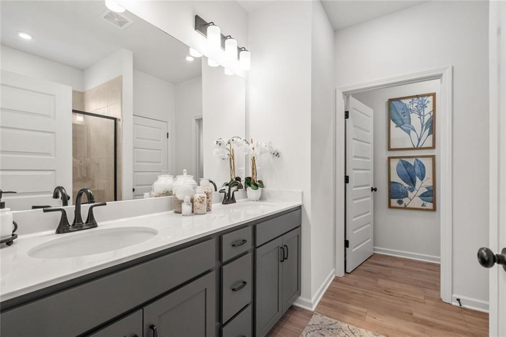 126 Sycamore Lane Calhoun, GA 30701 - Photo 18 of 31 a bathroom with a double vanity sink a mirror and shower