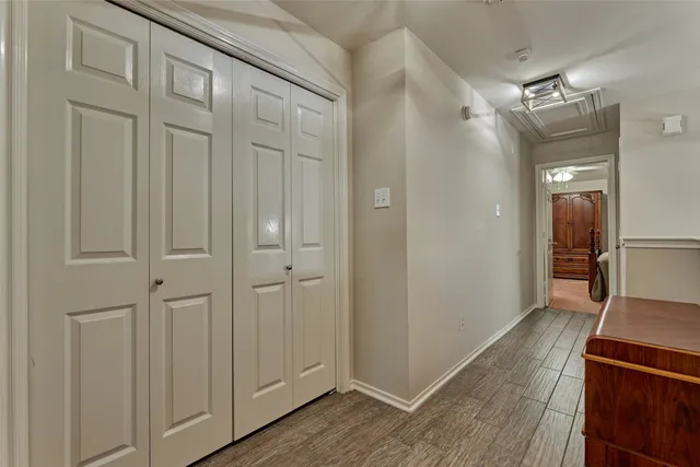 a view of a hallway with wooden floor