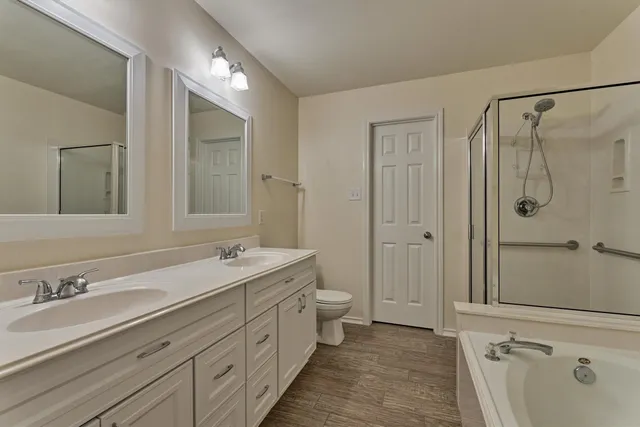 a spacious bathroom with a double vanity sink mirror double and shower