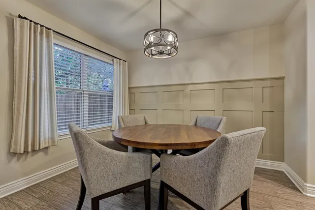 a view of a dining room with furniture wooden floor and chandelier