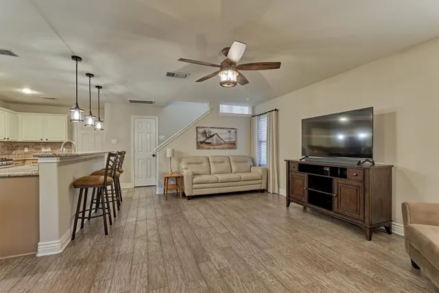 a view of a dining room with furniture and chandelier
