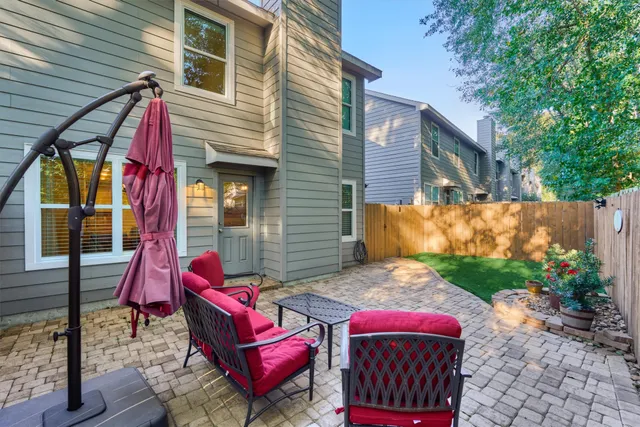 a backyard of a house with yard and outdoor seating