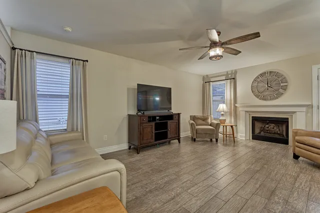 a living room with furniture a fireplace and a flat screen tv