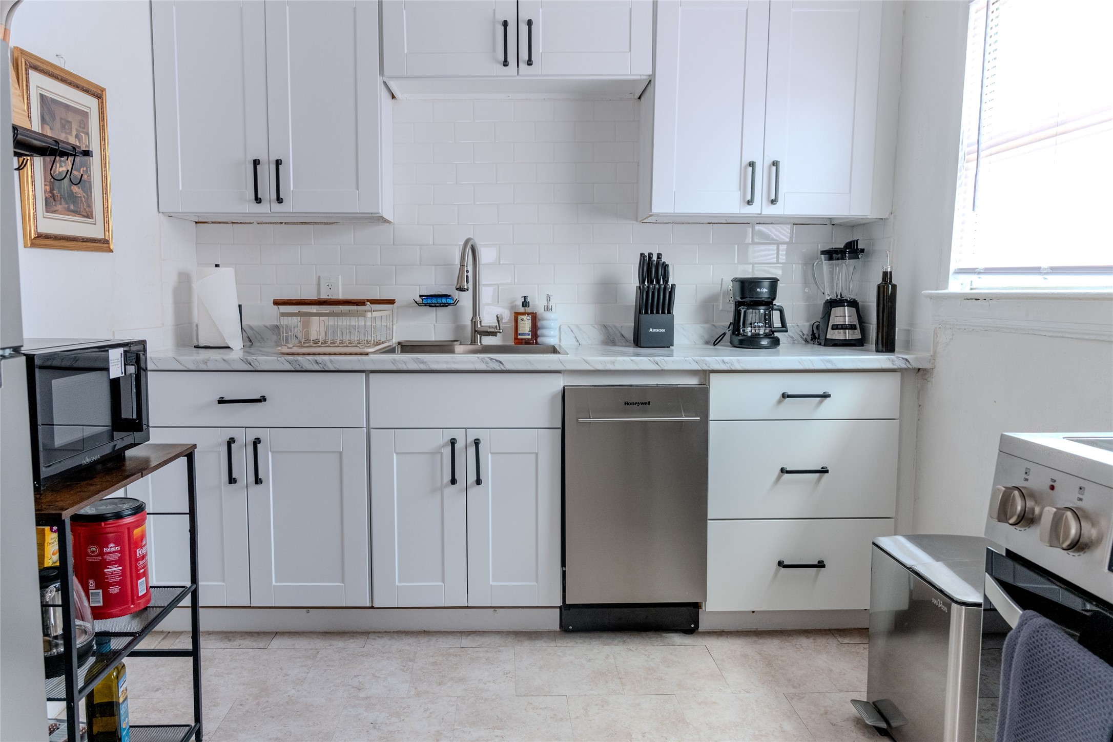 2016 Dunlavy Street, Unit 3 Houston, TX 77006 - Photo 8 of 22 a kitchen with white cabinets and sink