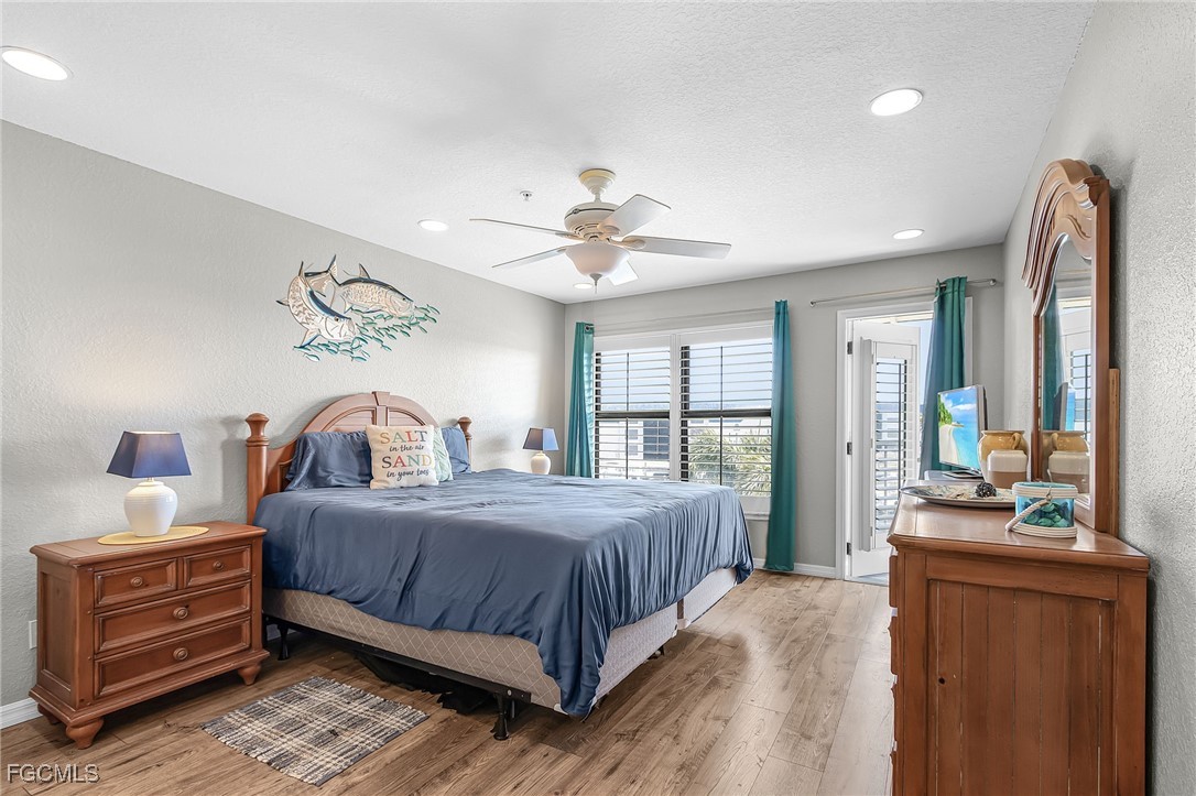 16641 Stringfellow Road, Unit 506 Bokeelia, FL 33922 - Photo 14 of 33 a bedroom with a bed and large windows