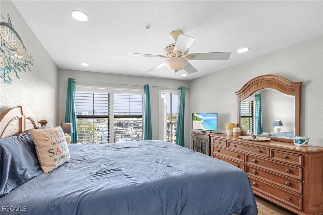 16641 Stringfellow Road, Unit 506 Bokeelia, FL 33922 - Photo 14 of 43 a bedroom with a large bed and a large window