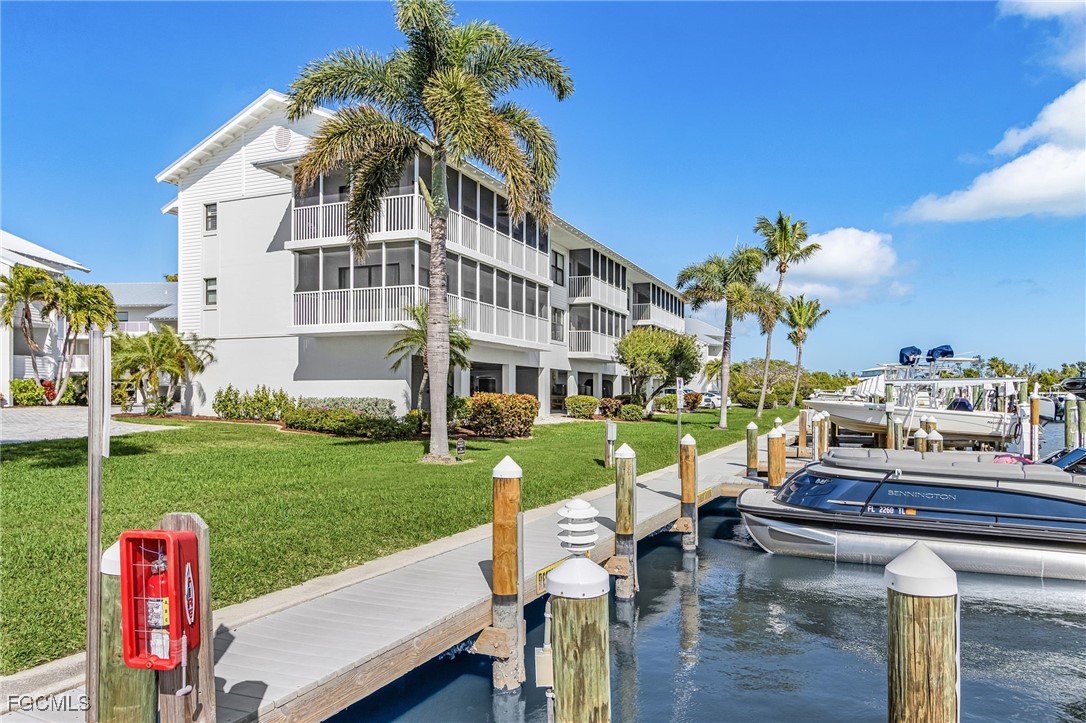 16641 Stringfellow Road, Unit 506 Bokeelia, FL 33922 - Photo 26 of 43 a front view of a house with a yard table and chairs