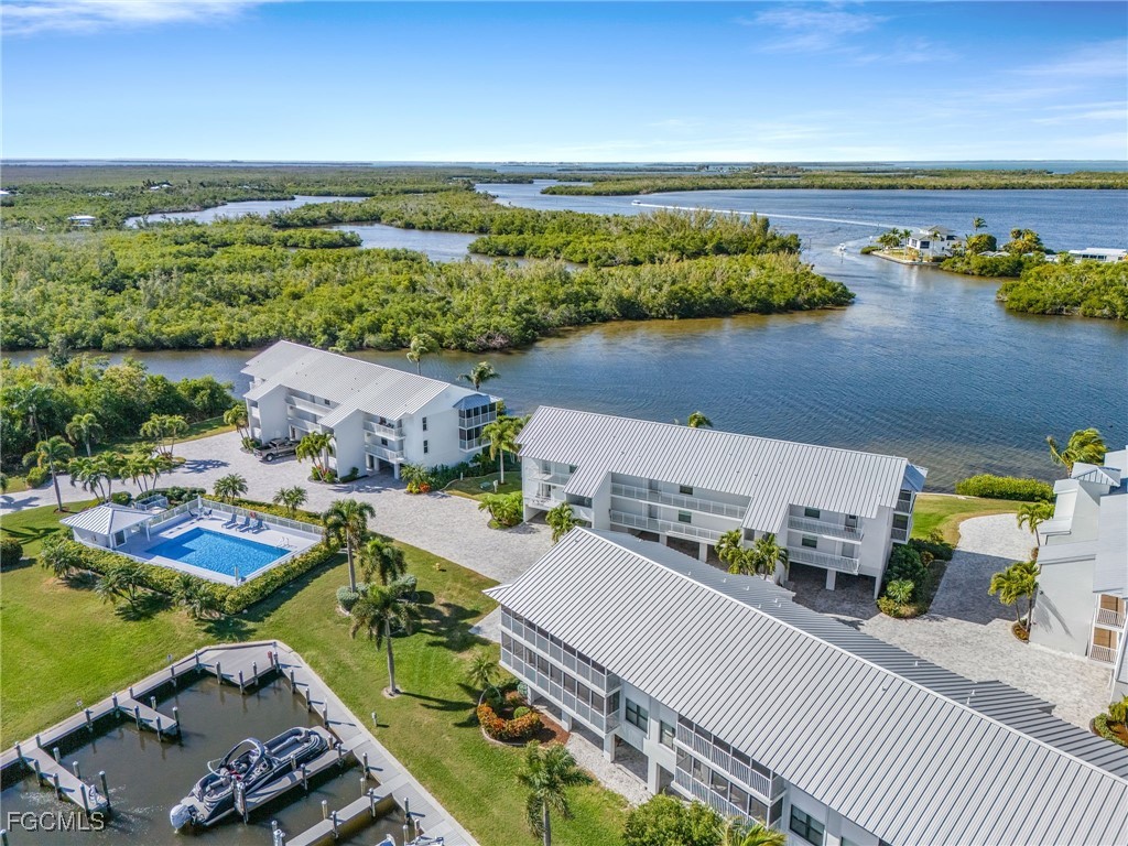 16641 Stringfellow Road, Unit 506 Bokeelia, FL 33922 - Photo 27 of 43 an aerial view of a house with garden space and outdoor seating