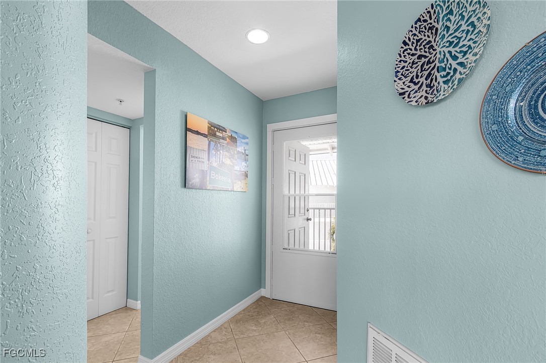 16641 Stringfellow Road, Unit 506 Bokeelia, FL 33922 - Photo 3 of 33 a view of an entryway with wooden floor
