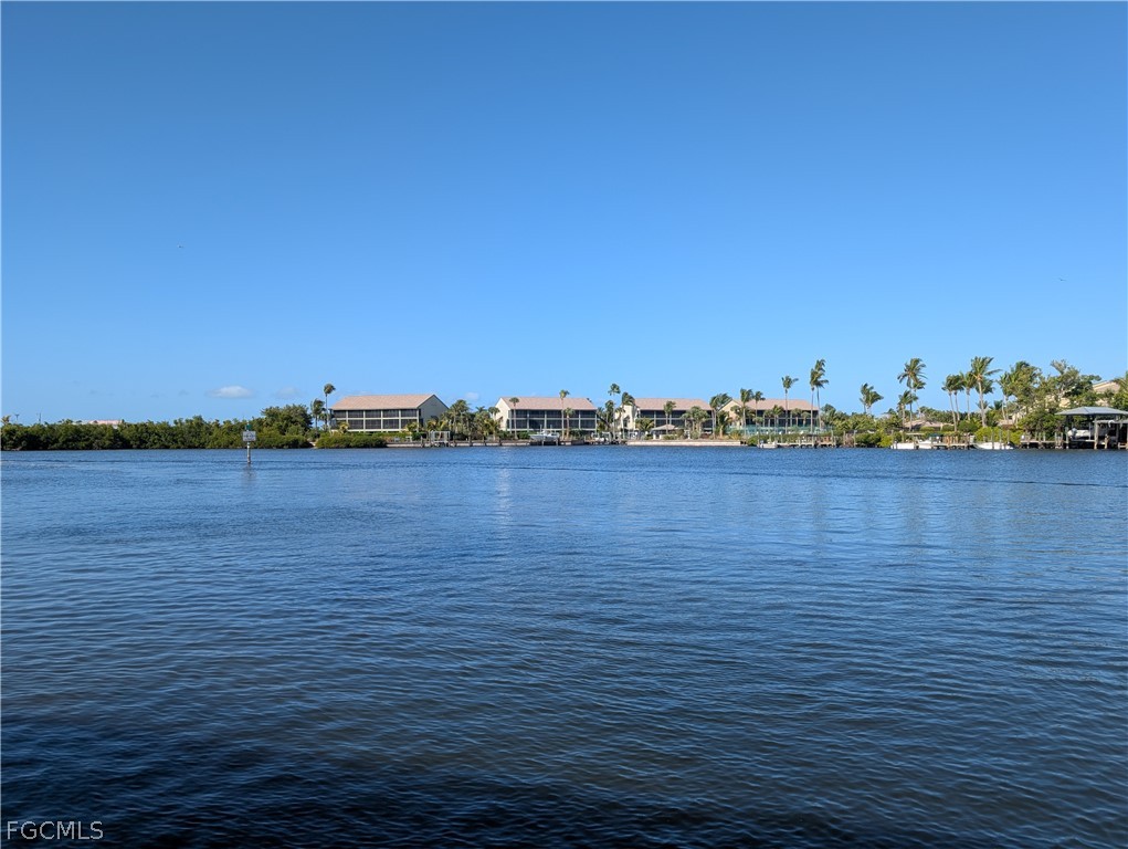 16641 Stringfellow Road, Unit 506 Bokeelia, FL 33922 - Photo 40 of 43 a view of an ocean with boats and trees in the background