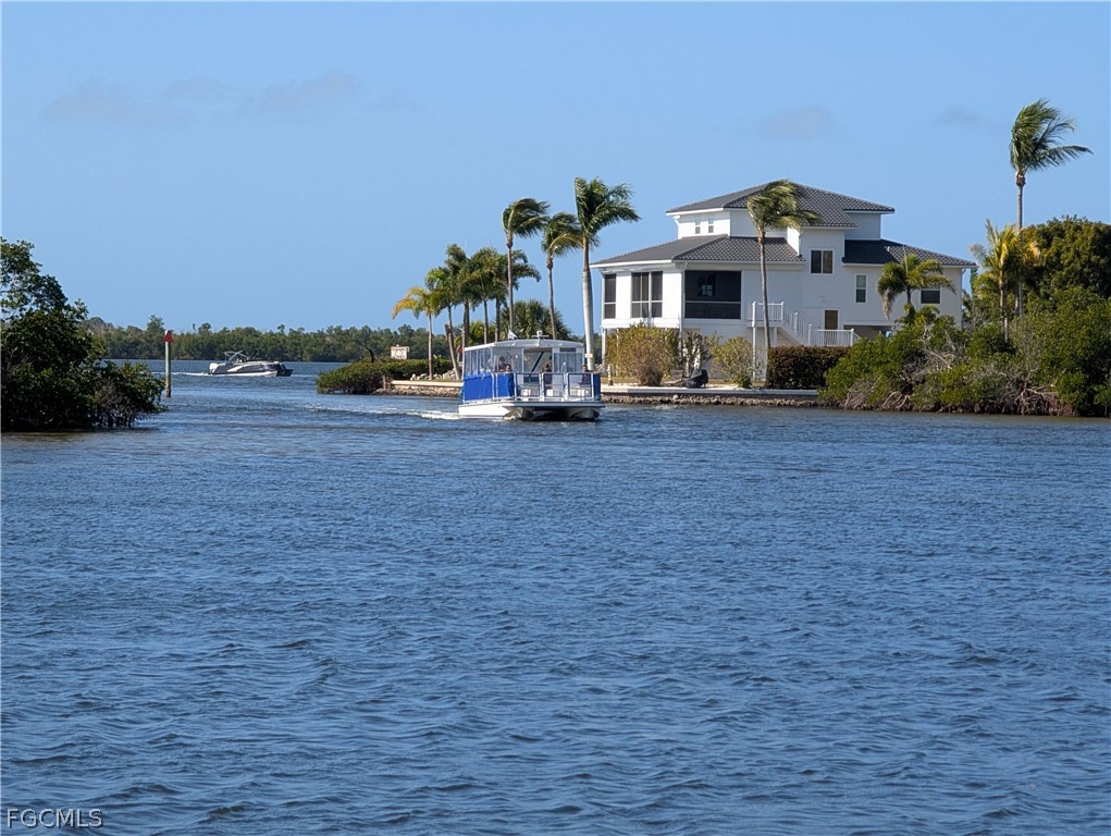 16641 Stringfellow Road, Unit 506 Bokeelia, FL 33922 - Photo 42 of 43 a front view of a house with a yard and garage