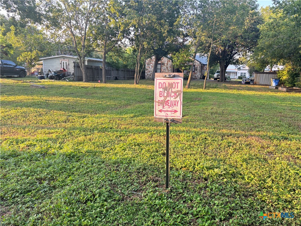 615 East Walnut Street Seguin, TX 78155 - Photo 3 of 7 a sign board with yard in the back