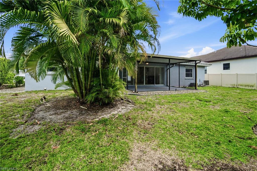 178 Bermuda Road Marco Island, FL 34145 - Photo 18 of 44 The property includes a spacious backyard, mature palm trees, and a covered patio area with plenty of room for a pool.