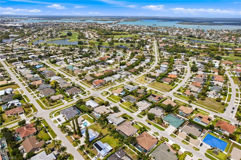 178 Bermuda Road Marco Island, FL 34145 - Photo 42 of 44 An aerial view of the property's neighborhood, showcasing residential streets, mature trees, and nearby gulfront homes.