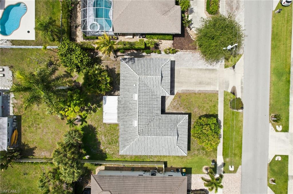 178 Bermuda Road Marco Island, FL 34145 - Photo 44 of 44 The property features a tile roof, a large concrete driveway with ample parking for guests and plenty of room for a pool or addition.