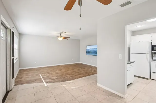 a kitchen with granite countertop white cabinets stainless steel appliances and a sink