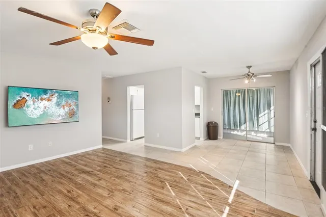 a living room with furniture a rug and a large window