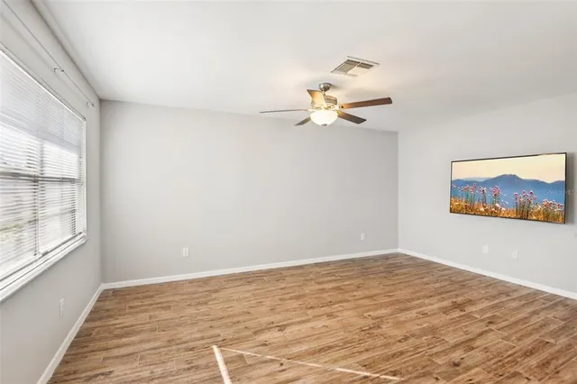 wooden floor in an empty room with a window