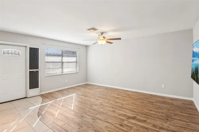 a living room with furniture a rug and a window