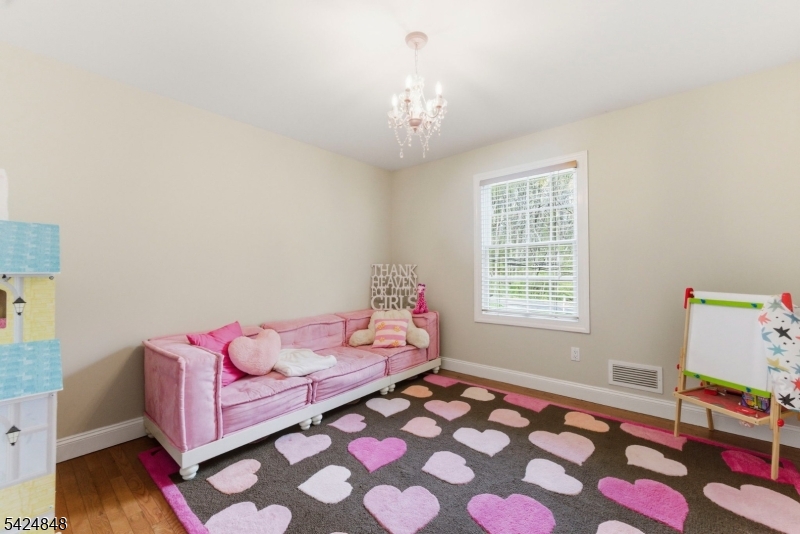 18 Valhalla Road Montville, NJ 07045 - Photo 23 of 33 a living room with furniture and a chandelier