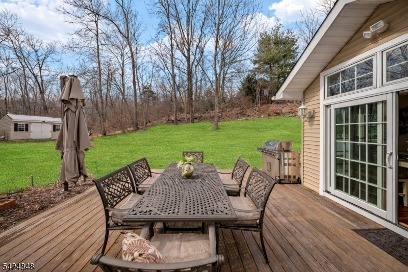 18 Valhalla Road Montville, NJ 07045 - Photo 30 of 33 a view of a patio with table and chairs with wooden floor and fence