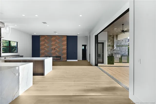 a view of swimming pool with seating area and trees in the background