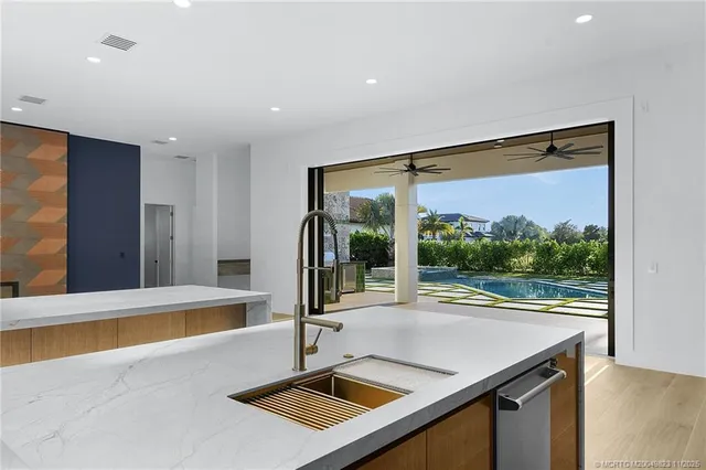 a view of a house with pool and sitting area