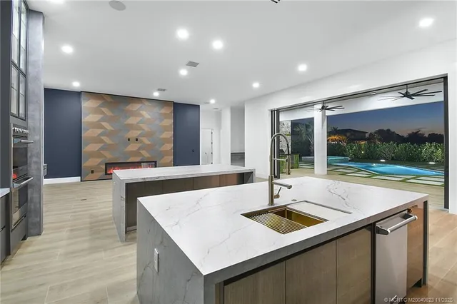 an aerial view of a city with lots of residential buildings and lake view in back