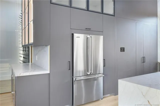 a view of a house with a yard and potted plants