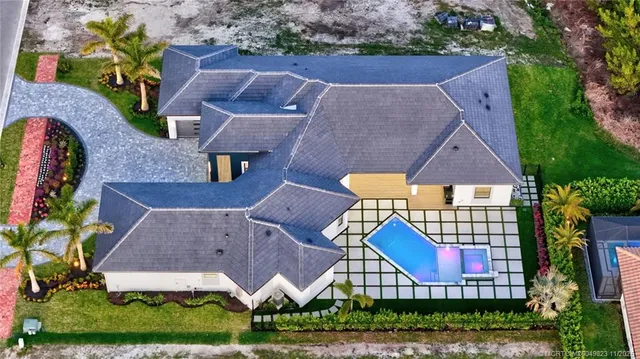 a view of an empty room with windows and a kitchen