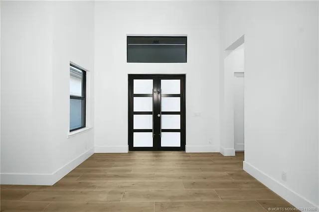 an empty room with windows and closet