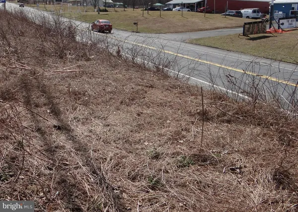 a view of a yard with wooden fence