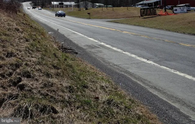 a view of a city street with parked cars