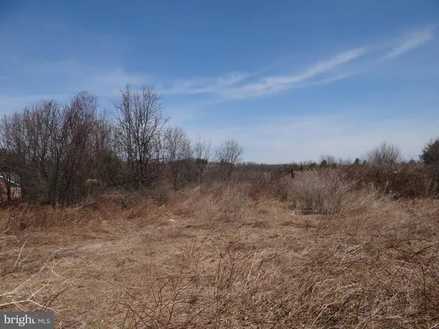 a view of a rural road with a barn