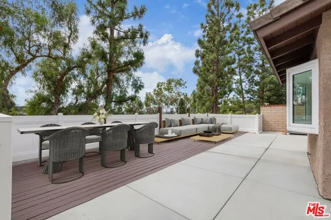 a view of backyard with a deck and wooden floor