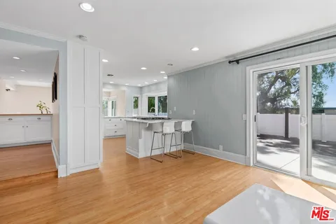 a view of kitchen with furniture and wooden floor