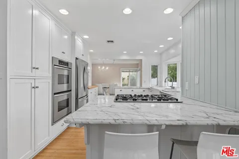 a kitchen with stainless steel appliances granite countertop a sink and cabinets