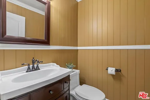 a bathroom with a sink a toilet and mirror