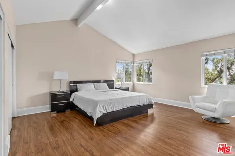 a spacious bedroom with a bed and window