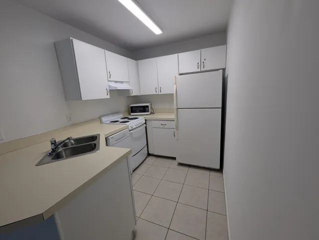 a bedroom with a bed and a sink