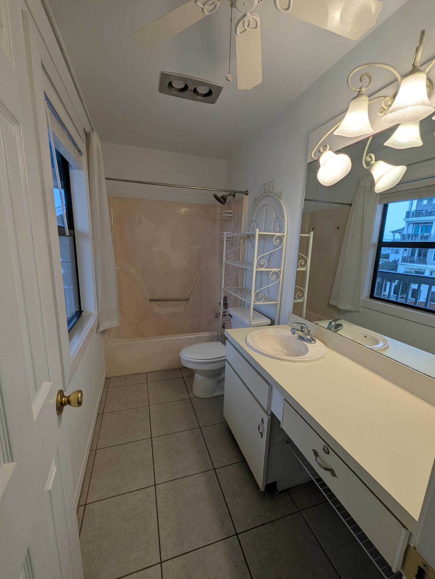 126 South Walton Lakeshore Drive, Unit 304 Inlet Beach, FL 32461 - Photo 9 of 13 a bathroom with a granite countertop sink a toilet a mirror and shower