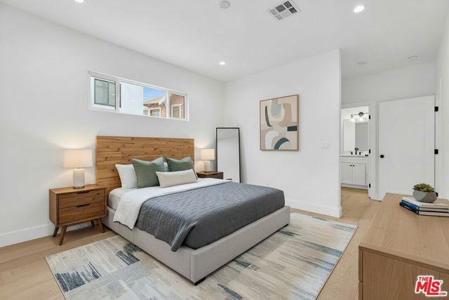 a bedroom with a bed and a dresser