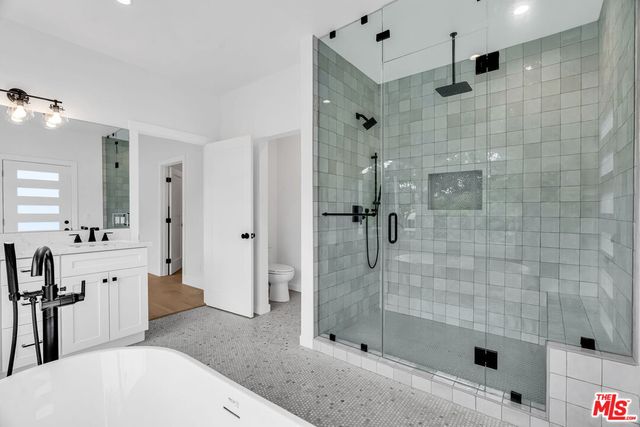 a bathroom with a shower and a sink