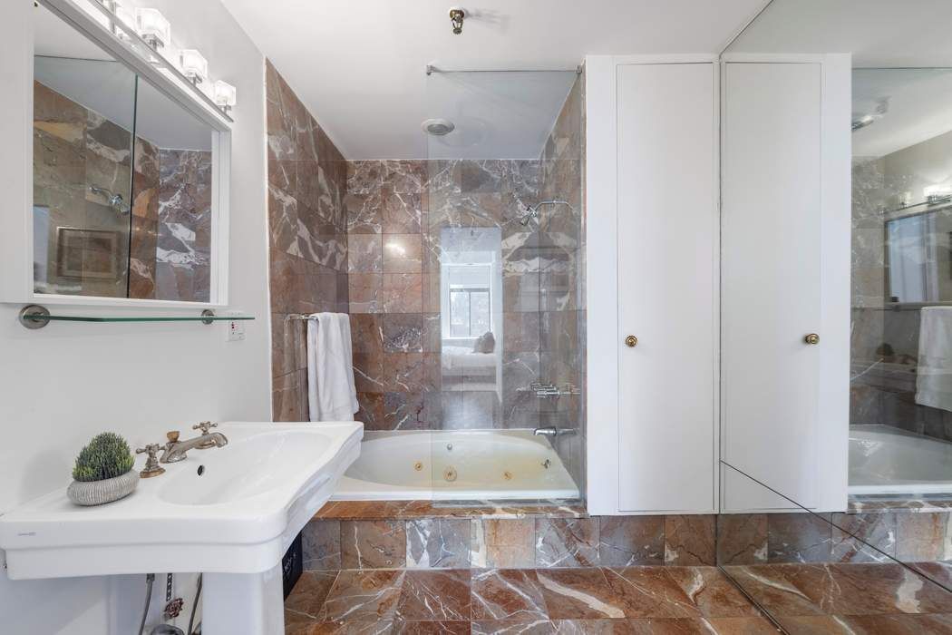 30 West 15th Street, Unit 6S Manhattan, NY 10011 - Photo 11 of 21 a bathroom with a sink and a shower