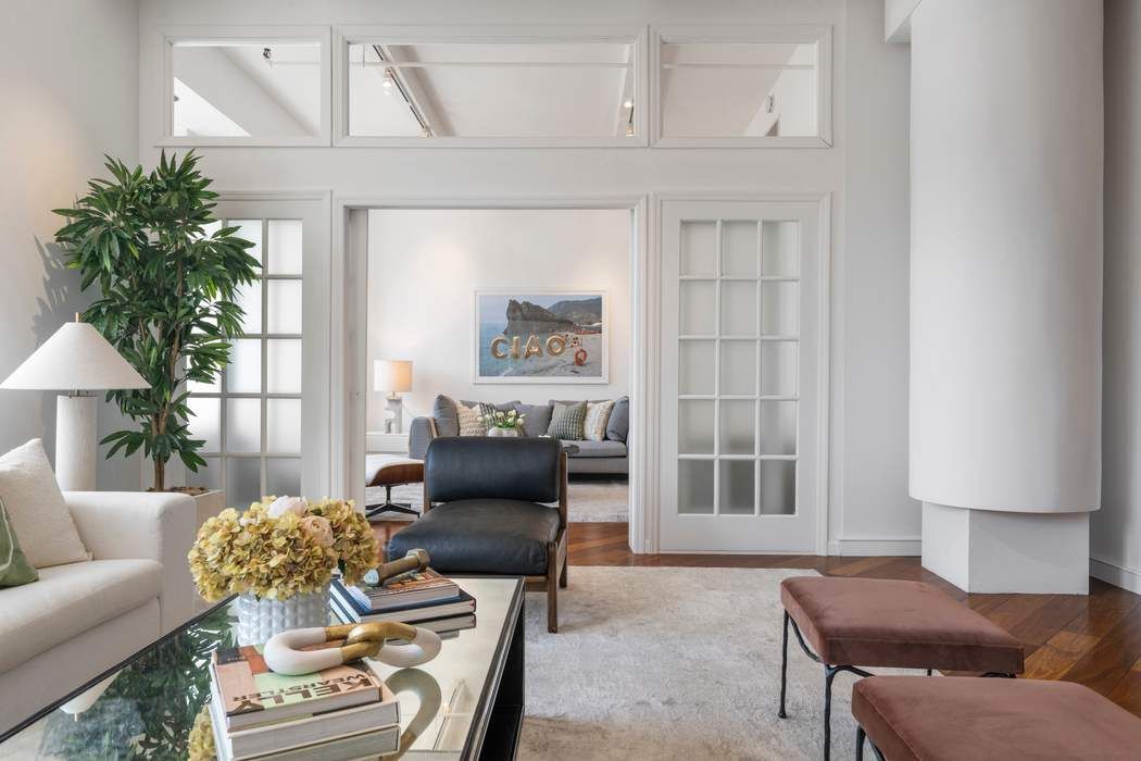 30 West 15th Street, Unit 6S Manhattan, NY 10011 - Photo 12 of 21 a living room with furniture and a potted plant