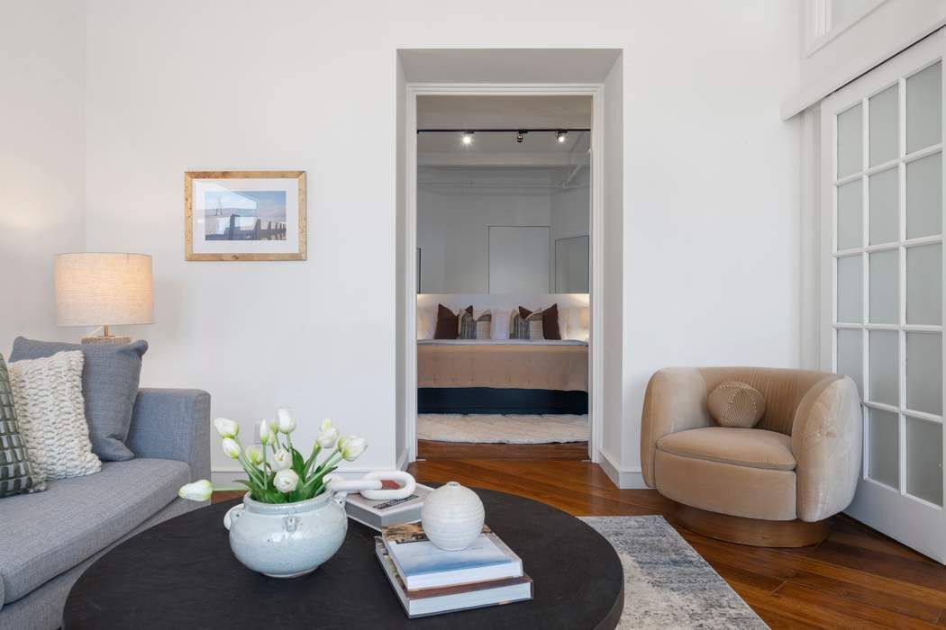 30 West 15th Street, Unit 6S Manhattan, NY 10011 - Photo 13 of 21 a living room with furniture and a potted plant