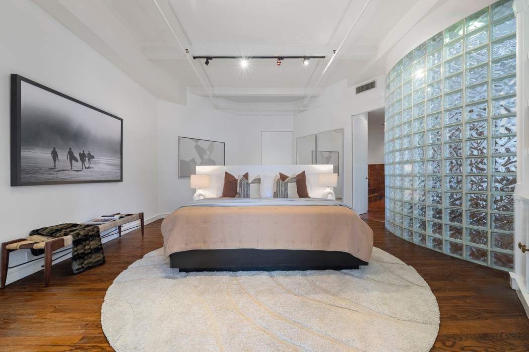 30 West 15th Street, Unit 6S Manhattan, NY 10011 - Photo 14 of 21 a bed room with a bed and a painting on the wall