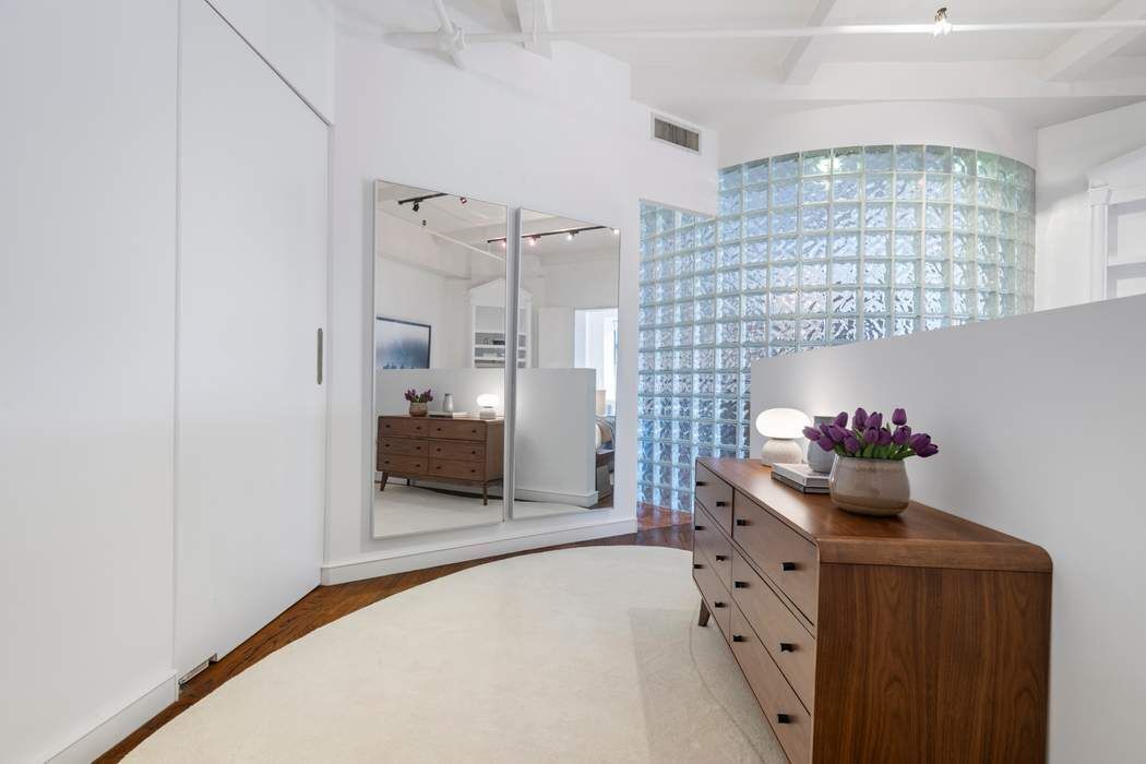 30 West 15th Street, Unit 6S Manhattan, NY 10011 - Photo 16 of 21 a hallway with a chandelier